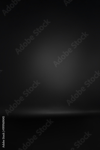 Professional black studio background with soft lighting gradient. This high-quality image features a seamless dark paper texture with a subtle spotlight effect in the center