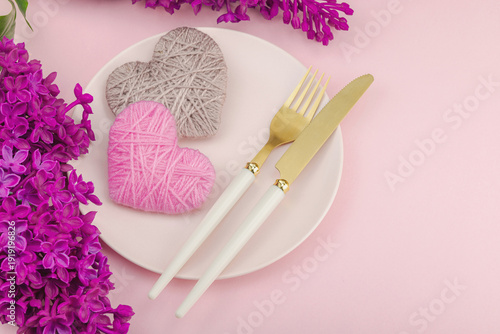 Gentle spring table setting with handmade hearts and lilac flowers.Valentine's or Mothers Day