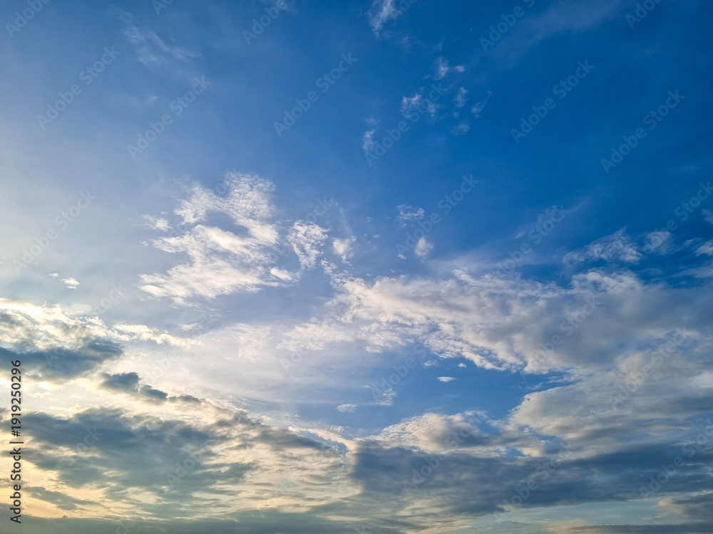 Fototapeta premium Dramatic blue sky with swirling white clouds creating a beautiful natural atmospheric background