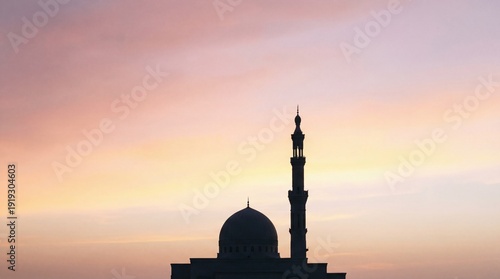 Silhouette of mosque with dome and minaret at sunset