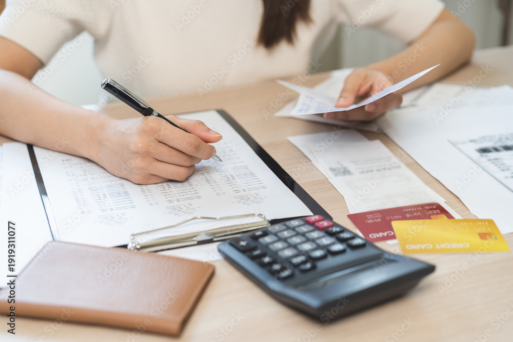 Naklejka premium Deduction planning, debt asian young woman calculating money balance of finance from bill and income, cost budget expenses for pay money form personal individual on table at home. Financial concept.