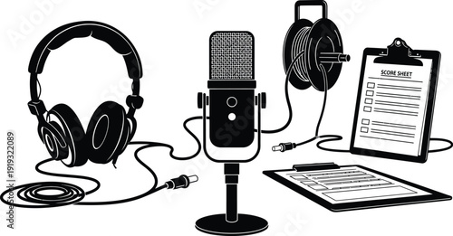 A podcast setup includes a microphone, headphones, a reel of cable, and two clipboards with paper.
