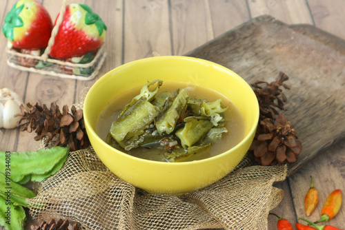 Obraz na plátne Sayur asam (or sayur asem), a refreshing Indonesian tamarind soup, features wing beans simmered in a clear, tangy broth infused with tamarind