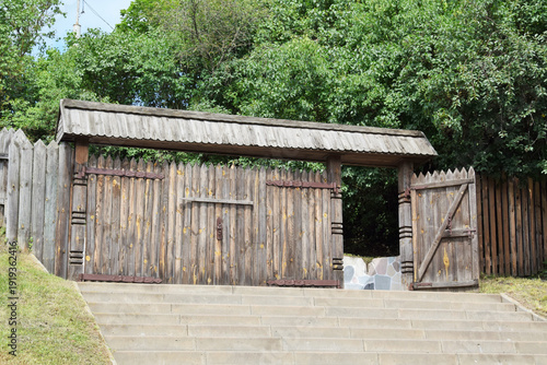 Large wooden gates and part of a fence, made in an antique style