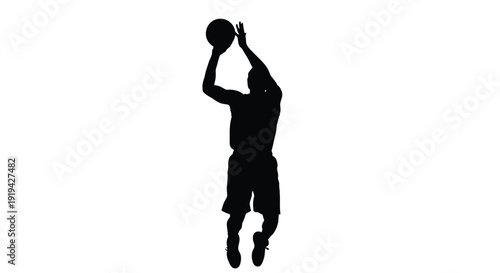 Silhouette of a professional basketball player jumping high to take a jump shot with the ball