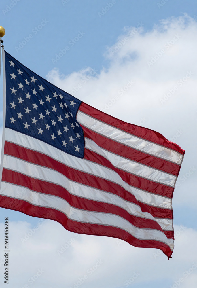 Fototapeta premium shot undulating american flag waving gently bright blue sky crisp white clouds breezy summer
