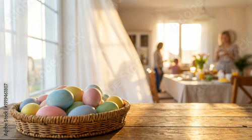 Basket of pastel Easter eggs on wooden table with copy space. Warm family morning and spring home celebration concept