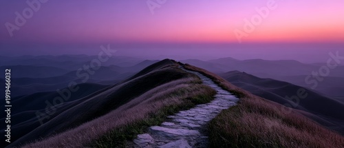 Pathway through misty mountains at twilight