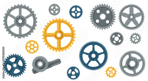 Various mechanical gears and cogs in different sizes and metallic colors are spread out on a white surface.