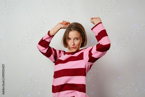 happy young girl raising hands victory wide smile triumph celebration achievement excitement positive energy success