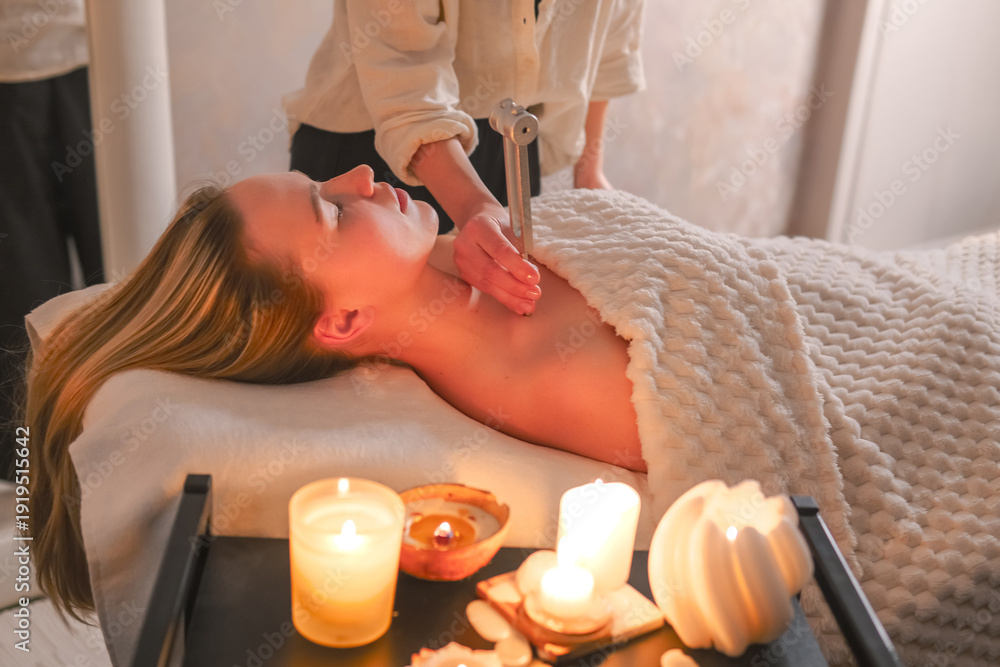 Φωτογραφία Facial massage and tuning fork sound therapy in candlelit spa, holistic skincare wellness ritual, relaxation and stress relief, self care, energy balance