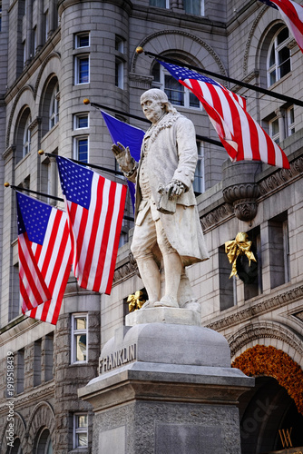 Fotografija Statute of Benjamin Franklin in Washington DC with American Flag