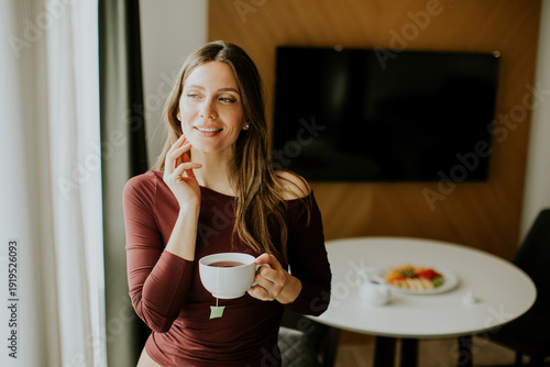 Woman enjoying tea in a mod...