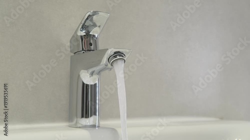 Faucet, water and hand with touch for hygiene, cleanliness and modern design in bathroom. Flow, sink and chrome tap for daily routine and sanitation.