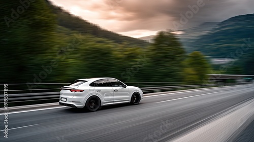 SUV drives on a highway surrounded by mountains with sunlight shining through. The scene shows motion with clear space for text.