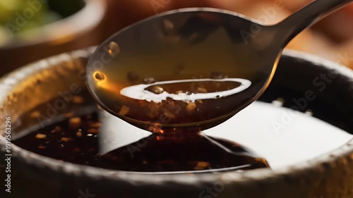 Close up of brown liquid pouring into a bowl with shallow depth of field