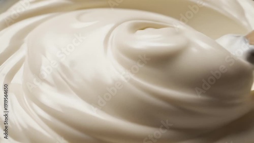 Close up of swirled creamy white substance with soft lighting and subtle textures