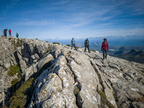 Hikers ascending Puig Tomir, Escorca, Natural area of the Serra de Tramuntana., Majorca, Balearic Islands, Spain