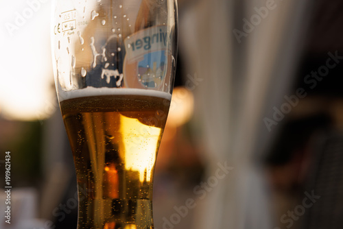 Foto Golden beverage reflecting sunset hues during a peaceful evening gathering in an