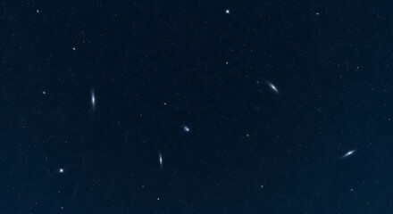 Dark night sky with numerous stars and streaks of light, possibly shooting stars