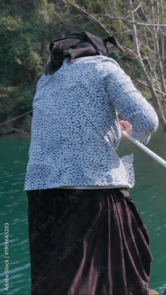In Hang Than Lim, Yen Minh, Ha Giang, Vietnam, a woman pulls a raft ...