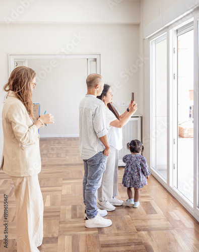 Family viewing new home for rent or sale with real estate agent