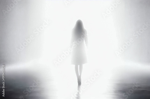 Monochrome image of a woman walking into the light