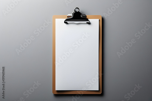 Minimalist wooden clipboard with blank white paper on a grey background. Professional mockup for checklists, medical records, or business notes with copy space for design.