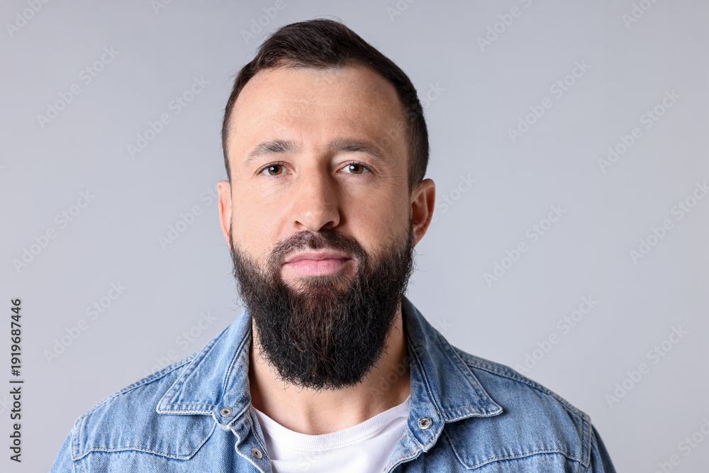 Fototapeta premium Man with mustache and beard on light grey background