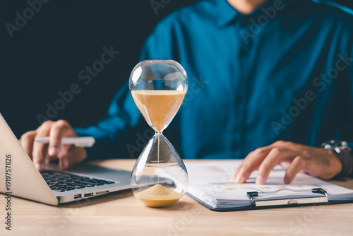 Bilde på lerret Hourglass time pressure on business document management, professional busy with