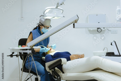 Dentist examining patient in modern clinic, providing professional dental care and oral health treatment