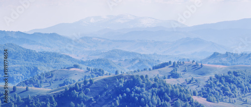 View of the evening haze, hills and mountain slopes in sunset light