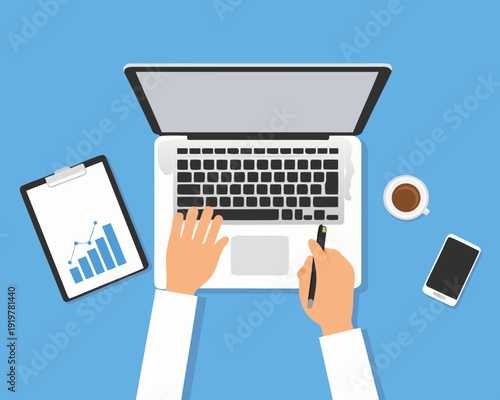 Overhead view of a person working on a laptop with office supplies