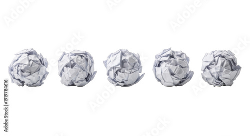 Five crumpled paper balls in a row, representing failed ideas or frustration