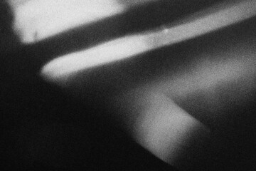 Black and white abstract background with heavy grain texture, featuring horizontal motion blur and dark cinematic gradients.
