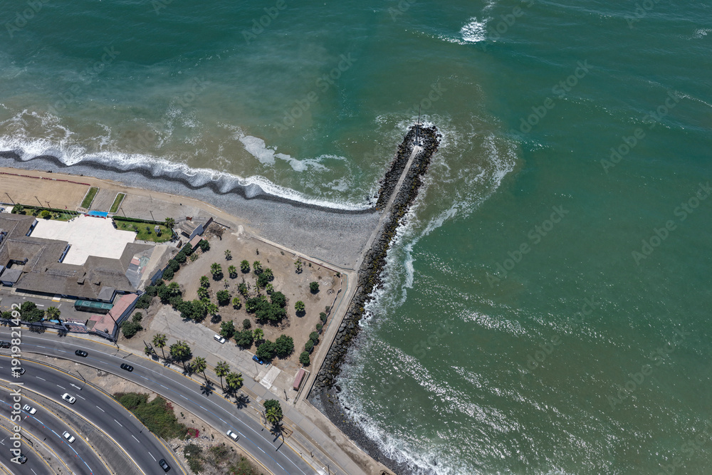 Εκτύπωση καμβά Aerial view of rock breakwater and highways alongside cliffs and ocean