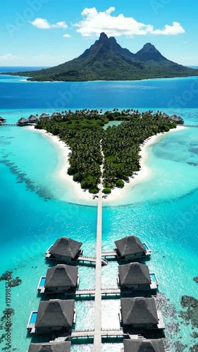 Aerial view of luxurious overwater bungalows leading to a tropical island resort