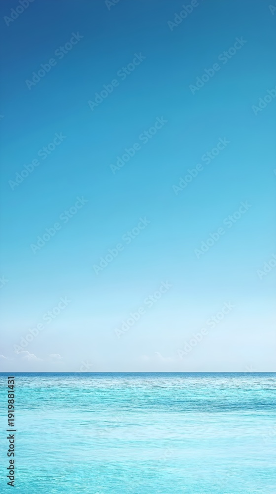 Fototapeta premium Clear blue sky over turquoise ocean water image