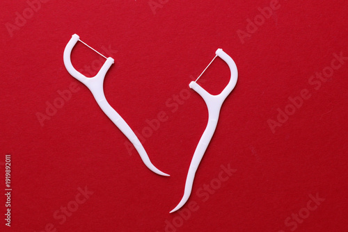 Quadro em tela Floss toothpicks on red background