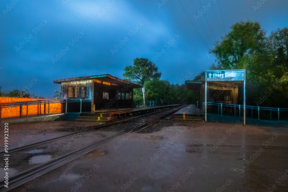 Naklejka premium Train tracks, at the Chepe train station at night, in the town of Areponamichic, Chihuahua