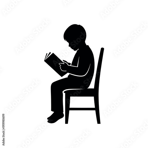 Silhouette of a young boy sitting on a chair and reading a book 1.
