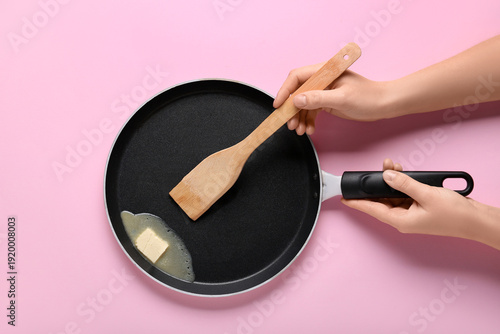 Female hands holding frying...