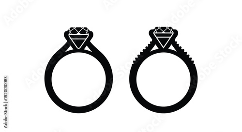 Two diamond engagement rings presented in a stark black silhouette