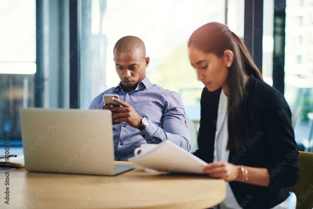 Fototapeta premium Business, man or phone with texting in meeting for story research, email source or check schedule. Coworking, journalist and tech at publishing agency for article review, notification and news update