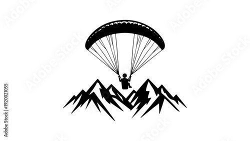 A person paragliding over a mountain range in a serene landscape