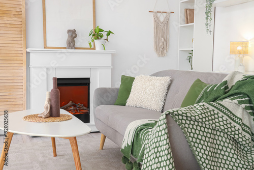 Fireplace, table and sofa i...