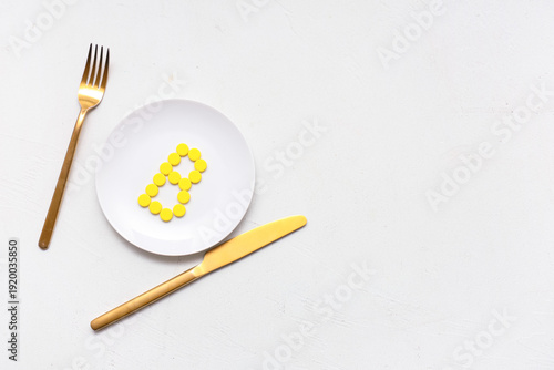 Plate with vitamin B pills ...