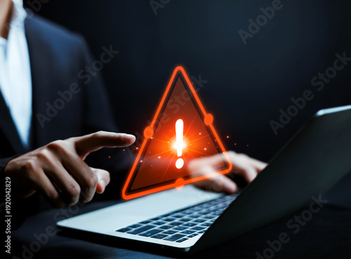 Photos Cyber security warning concept, businessman pointing at laptop with glowing red
