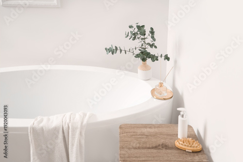 Table and bathtub near whit...