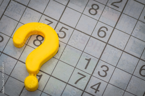 Sudoku Puzzle Grid with Large Yellow Question Mark Symbolizing Challenge and Problem-Solving
